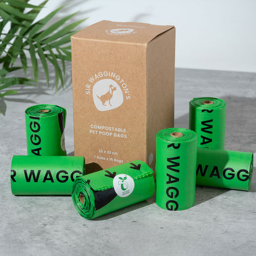 A packaging box with 'Sir Waggington's Compostable Pet Poop Bags' text, alongside five rolls of green, compostable dog poop bags.